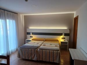 Postel nebo postele na pokoji v ubytování Hostal Restaurante El Castillo