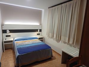 Postel nebo postele na pokoji v ubytování Hostal Restaurante El Castillo