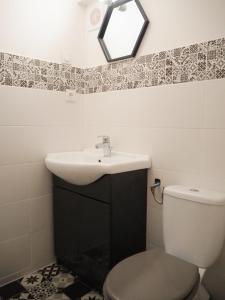 a bathroom with a sink and a toilet at Maison Salamandre in Remoulins