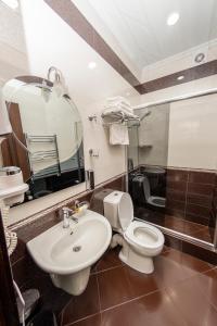 a bathroom with a toilet and a sink at Eiffel Hotel in Batumi