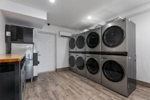 a row of washing machines in a laundry room at Extended Stay Gun Barrel City in Gun Barrel City