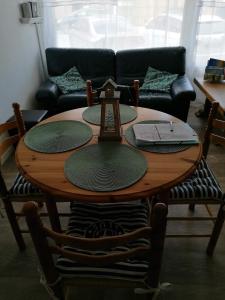 a wooden table in a living room with a couch at Julie's Home in Bray-Dunes