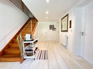 a staircase in a home with white walls and wooden floors at Vogelmann Suite in Pfronten