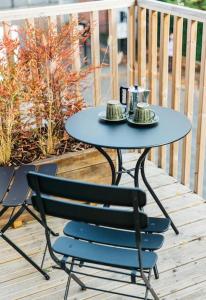 a blue table and a chair on a deck at Carmen Eco-Pod / Treehouse, Close to Cabot Circus in Bristol