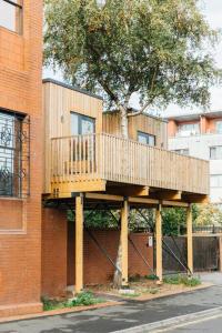 a wooden deck on the side of a building at Carmen Eco-Pod / Treehouse, Close to Cabot Circus in Bristol