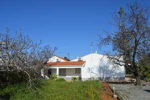 een wit huis met een rood dak bij Quinta das Figueiras in Vila Nova de Cacela