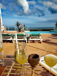 dois copos de vinho em cima de uma mesa em Fuseta Ria Resort - Villa Jasmine - Pool, Jacuzzi & Sea Views em Fuzeta