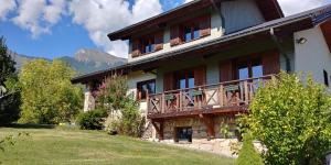 a large building with a balcony on the side of it at Rêverie Champêtre in Verrens-Arvey