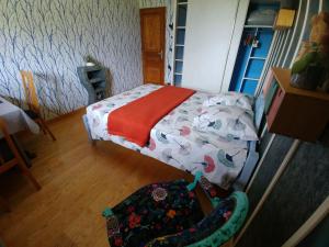 een kleine slaapkamer met een bed met een deken bij Rêverie Champêtre in Verrens-Arvey