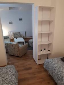 a living room with a couch and a chair at Apartment Ana in Slavonski Brod +5 photos