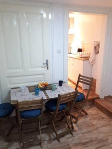 a kitchen with a table and chairs and a kitchen with a table and chairsktop at Apartment Ana in Slavonski Brod