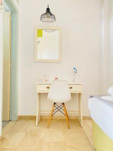 a white desk with a white chair in a bedroom at Gerani Studios in Astypalaia Town