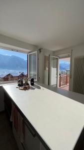 a kitchen with a white counter top and a window at Al Bel VEDER in Levico Terme