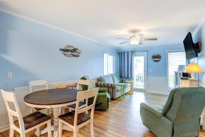a dining room and living room with a table and chairs at Seaspray 134 in Atlantic Beach