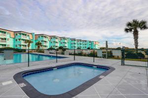 a swimming pool in front of a apartment complex at Seaspray 134 in Atlantic Beach