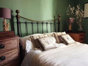 a bed with two pillows on top of it at The Writer's House in Canterbury