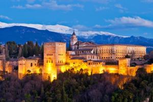 a large castle is lit up at night at Cortijo Blanco in Albondón