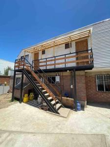 a house with a staircase on the side of a building at Departamento N con hermosa vista al mar in Los Vilos +7 photos