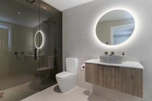 a bathroom with a toilet and a sink and a mirror at Hicks Cottage in Queenstown +19 photos