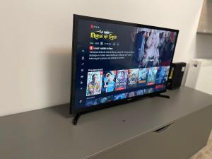 a flat screen tv sitting on top of a table at Iulius Mall River Tower in Iaşi