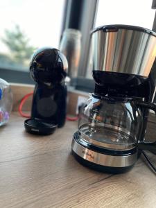 a blender sitting on top of a wooden table at HOOliRé17 3étoiles in Ars-en-Ré