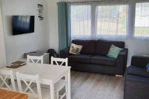 a living room with a couch and a table at Woolacombe Breaks - ‘Sea La Vie’ in Woolacombe