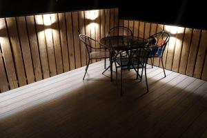 a table and two chairs sitting on a porch at Woolacombe Breaks - ‘Sea La Vie’ in Woolacombe