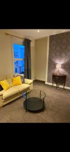 a living room with a couch and a table at Exclusive apartment in Bristol in Bristol