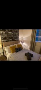 a bedroom with a bed with yellow pillows and a window at Exclusive apartment in Bristol in Bristol