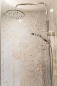 a shower in a bathroom with a marble wall at Holloway House in Bath