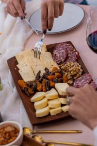 a plate of cheese and other food on a table at Castillo de Piedra Tafi del Valle in Tafí del Valle