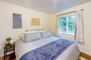 1 dormitorio con cama y ventana en Treehouse by the Sea, en Cape Meares