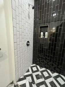 a bathroom with a shower with black and white tile at Midtown Casablanca in Memphis