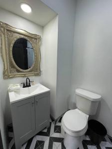 a bathroom with a toilet and a sink and a mirror at Midtown Casablanca in Memphis