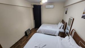 A bed or beds in a room at Alex sea view apartment - families only