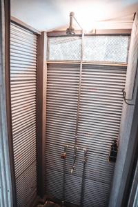 a shower in front of a large metal garage door at Warehouse Hostel Koh Tao in Koh Tao