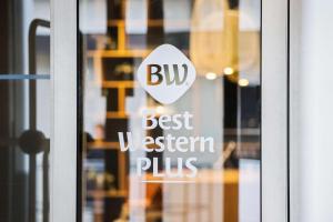 a sign on a glass door that reads bud best western plus at Best Western Plus Airport Hotel in Copenhagen