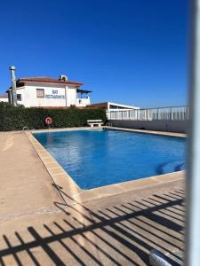 a swimming pool on the side of a building at Riviera patio in Miami Platja +19 photos