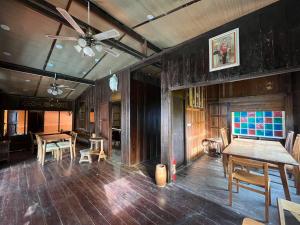 a room with wooden walls and wooden tables and chairs at Mesa Garden Villa in Chiang Mai