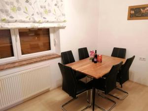 a dining room with a wooden table and black chairs at Laura Rennweg in Rennweg