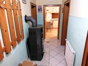 a black stove in a room with a hallway at Laura Rennweg in Rennweg