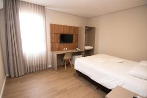 Postel nebo postele na pokoji v ubytování Hotel Maua