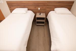Postel nebo postele na pokoji v ubytování Hotel Maua