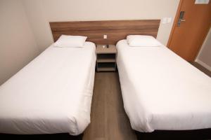 Postel nebo postele na pokoji v ubytování Hotel Maua