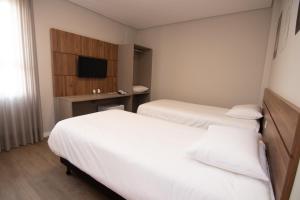 Postel nebo postele na pokoji v ubytování Hotel Maua