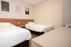 Postel nebo postele na pokoji v ubytování Hotel Maua