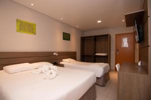Postel nebo postele na pokoji v ubytování Hotel Maua
