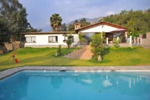 a house with a swimming pool in front of a house at Casa El Palto in Santa Eulalia