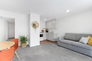 a living room with a couch and a table at Central town apartment in Queenstown