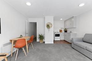 a living room with a table and a couch at Central town apartment in Queenstown